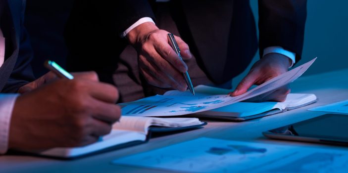 Close-up image of business partners working with financial documents